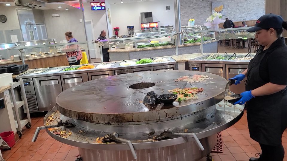 Dining room tables beside a self-serve buffet